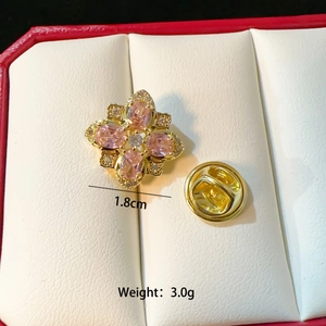 Detail of pink crystal flower brooch in 1.8cm diameter with gold plating and rhinestones