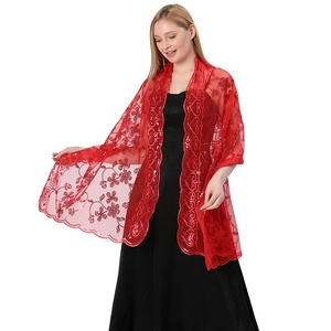 Detailed view of red sequined embroidered lace shawl on an elegant evening dress