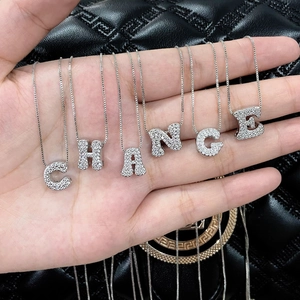 Silver alphabet letter pendant necklaces with cubic zirconia spelling CHANGE on black leather