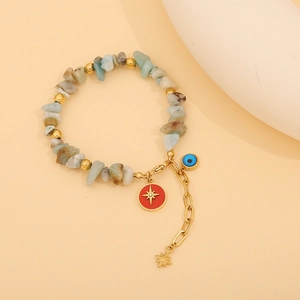 Close-up of bohemian stone bead bracelet featuring evil eye and star charms