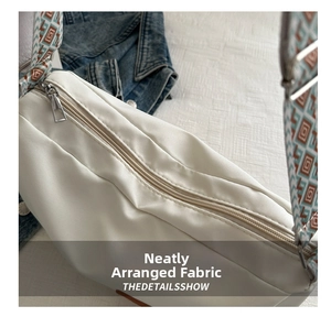 Detail of white nylon crossbody bag with vintage geometric pattern wide shoulder strap