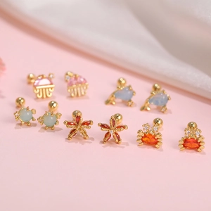 Golden sea animal stud earrings set with colorful zircons and opal sea creatures