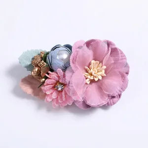 Detailed macro of fabric flower hair clip with pearls and rhinestones decoration