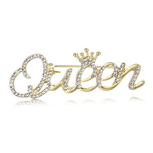 Sparkling gold Queen brooch with rhinestones and crown detail on a white background