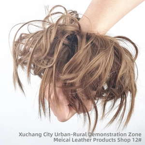 Close-up of light brown messy curly wig bun hair extension in shade 12 on white background
