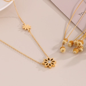 Detailed shot of gold daisy necklace with hollow petal pendant and crystal inlay on O-chain