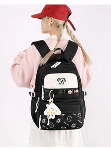 Detail view of durable school backpack with adjustable straps and cute decorative charms