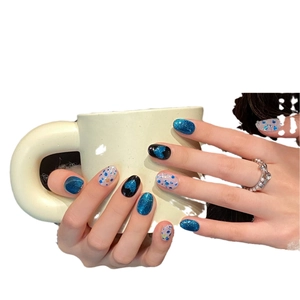Deep blue cat-eye press-on nails with glitter hearts and shimmering resin finish