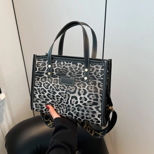 Chic leopard print large tote bag with black handles and a wide Vogue shoulder strap