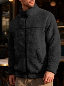 Close-up detail of soft black teddy fleece jacket featuring a stand collar and resin zipper