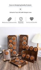 Detail of walnut wood jewelry trays with gold corners and soft velvet lining pads