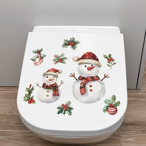 Detail of Christmas toilet lid decal featuring snowman, holly berries, and festive ornaments