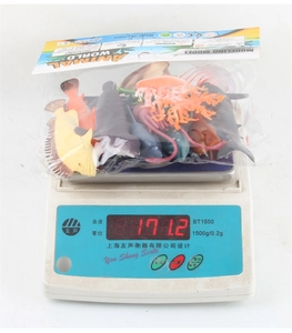 Detail shot of a 12-piece sea animal toy set on a digital scale weighing 171.2g