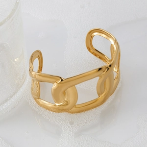 Minimalist gold hollow C-shaped open bracelet on glass with ice and foam background
