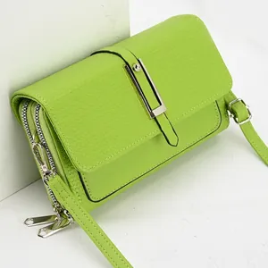Bright green woven pattern crossbody bag with double zipper and metal buckle detail