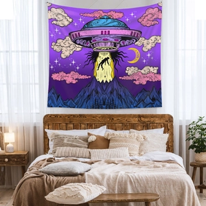 Detail of psychedelic UFO tapestry featuring purple and pink hues in a cozy bedroom setting