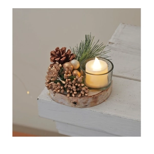 Close-up of Christmas candle holder with white LED candle, pine cones, and birch base