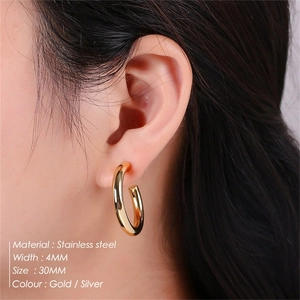Detail showing 4mm thick stainless steel C-shape earrings with 30mm diameter dimensions