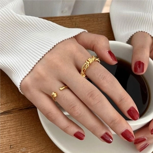 Gold plated sterling silver ring set with braided texture and ball detail on hand