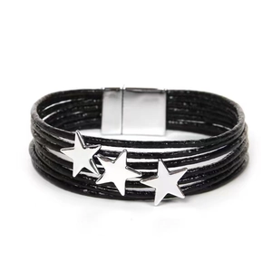 Detail of multi-layer black leather wrap bracelet with silver star accents and magnetic clasp
