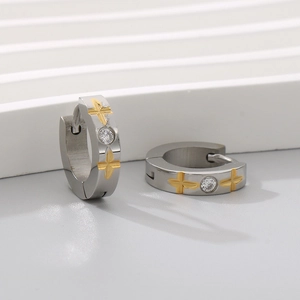 Detail of C-shaped hoop earrings featuring golden cross relief and a sparkling zircon stone