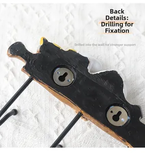 Detail view of the resin chef hook back featuring metal keyhole slots for wall mounting