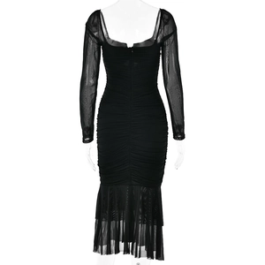 Detail view of the back of a black mesh dress showing ruffled fishtail hem and hidden zipper