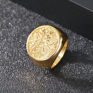 Macro detail of vintage Tree of Life relief and gold-plated finish on stainless steel ring