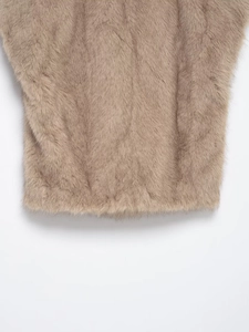 Close-up of soft light brown faux fur texture on a cropped sleeveless vest