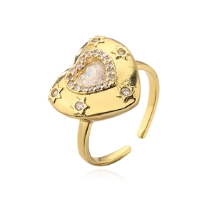 Detail of 18K gold plated heart ring with sparkling crystals and star-shaped engraving