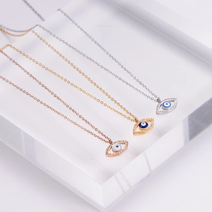 Minimalist evil eye necklace set in gold, rose gold and silver finishes with crystal detail