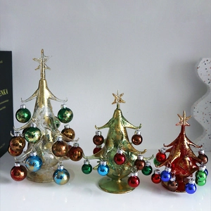 Three-piece set of glass Christmas tree ornaments in red, green, and gold with mini baubles