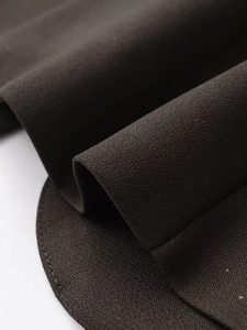 Macro detail of dark charcoal textured fabric for a slim fit professional blazer