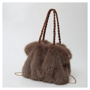 Detail of plush brown tote bag featuring woven handles and a gold metal chain strap