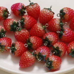 Vibrant red resin strawberry charms with green leaves and metal hooks for DIY jewelry