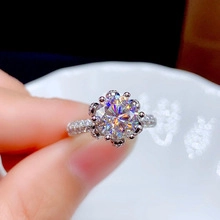 Macro shot of a silver six-prong setting ring with a round zircon and pave-set band