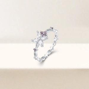 Detailed view of silver flower ring featuring purple zircon and clear stone accents