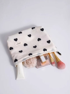 Creamy white heart-print cosmetic bag with makeup brushes and accessories storage