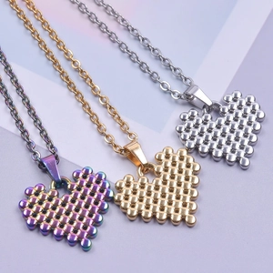 Detailed close-up of heart-shaped metal bead pendants in gold, silver, and rainbow finish