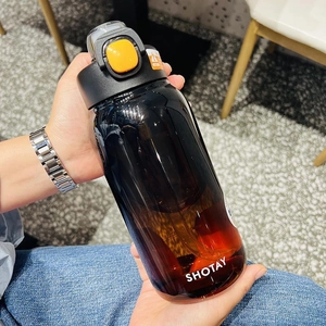 Detail of the brown gradient Tritan water bottle with a yellow button lid and carry handle