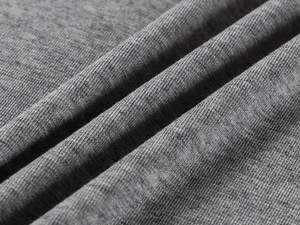 Macro shot of grey tencel wool fabric texture showing detailed knit pattern