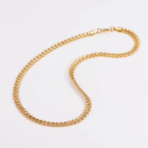 Detail shot of a sparkling gold stainless steel chain with a unique woven texture pattern