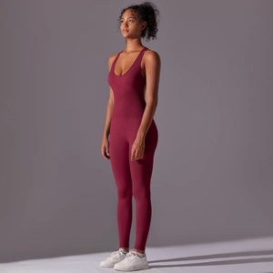 Side view of dark red seamless sculpting yoga jumpsuit featuring deep U-neck and tight fit