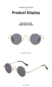 Detailed view of vintage round gold metal frame sunglasses with dark grey resin lenses