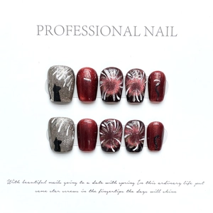Cat eye press-on nails with red glitter, black cat silhouette and firework patterns