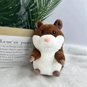 Cute brown and white stuffed hamster plush toy sitting in a cozy indoor setting