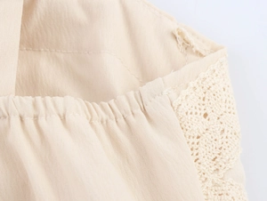 Macro detail of beige cotton-linen fabric with intricate lace trim and elastic stitching