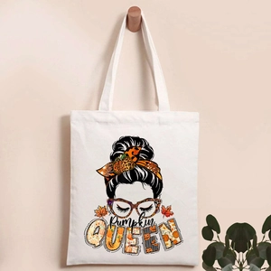 Detailed close-up of Pumpkin QUEEN graphic print on a cream canvas tote bag