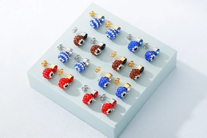 Macro view of evil eye and pavé ball stud earrings in diverse colors on a display