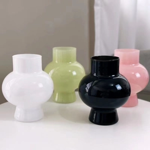 Collection of minimalist colorful glass vases in white, green, black and pink finishes